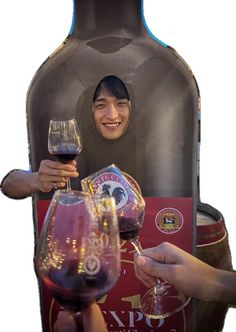 two people holding up wine glasses in front of a bottle and glass holder with the image of a smiling woman on it