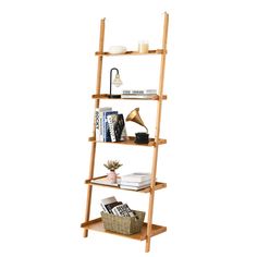 a wooden shelf with books and magazines on it, against a white background that is also used as a shelving unit