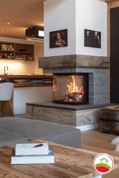 a living room filled with furniture and a fire place next to a counter top oven