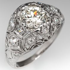 an antique style diamond ring with filigrees