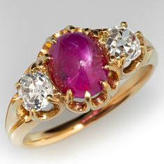 This dashing antique ring is centered with an eight -prong set oval cabochon cut star ruby, weighing 3.17 carats. The star ruby is flanked on either side by one (1) old mine cut diamond accent. The simplicity of design would make it a great ring for a man or woman. The ring measures 10.6mm at the top, rises 6.1mm above the finger, and tapers to 2.0mm wide by 1.4mm thick at the base of the shank. It is crafted in 18k yellow gold and is currently a size 7. Star Ruby Ring, Old Mine Cut Diamond, Antique Ring, Star Ruby, Diamond Star, Ruby Ring, Oval Cabochon, One 1, Antique Rings