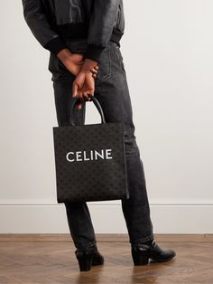 "CELINE HOMME's bold logo is one of the most recognisable in fashion, " we write in The Journal ; not least because it can turn simple accessories like this tote bag into a statement piece. Crafted from durable coated-canvas, it's patterned with the brand's 'Triomphe' monogram and has leather top handles. Celine Cabas Tote, Celine Cabas, Dior Tote Bag, Tote Bag For Men, Men Dior, Simple Accessories, Bold Logo, Luxury Men, Grab Bag