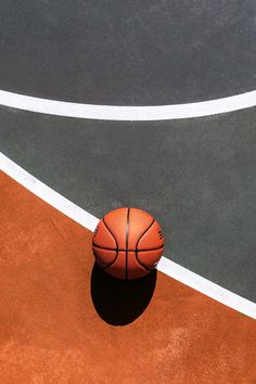 a basketball sitting on top of an orange court