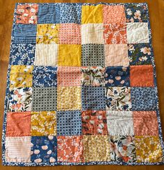 an old patchwork quilt is laying on the floor