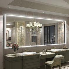 a large bathroom with two sinks and a chandelier