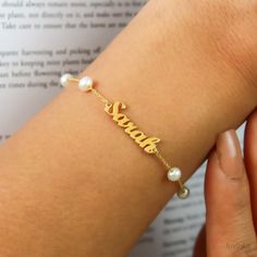 "14K Solid Gold Pearl Name Bracelet ❤️Finish:Solid Gold, Sterling Silver,14K Gold,Rose Gold HOW TO ORDER; Please select your preffered material from the menu while adding to card. Please write your custom NAME a note during check out. Comes with an Elegant gift box and all of my bracelets come with an extra 1\" extension ❤️Nickel Free ❤️Tarnish Resistant ❤️High Quality Materials T U R N ∙ A R O U N D ∙ T I M E * All items are custom made to order. Our turn around time is about 4 -6 business days. This can change during peak seasons. Please check our home page for the most current times. ❤️Please contact me for further questions and custom design jewelry. Thank you for shopping with me!!" Customized Dainty Bracelets, Elegant Name Bracelet For Bridesmaid Gift, Dainty Adjustable Name Bracelet For Bridesmaid Gift, Dainty Name Bangle Bracelet For Wedding, Adjustable Personalized Gold Bracelet For Wedding, Personalized Adjustable Gold Bracelet For Wedding, Elegant Gold Beaded Bracelet With Custom Name, Customized Gold Bracelets For Bridesmaids, Handmade Gold Name Bracelet For Wedding