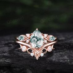 "This is a natural green moss agate  engagement ring in solid gold,about 6x8mm 1.3ct pear cut.  The accent stones are round 1.5mm moissanites and marquise cut 2x4mm moss agate. The matching band stones are round lab opals. The band width about 1.3-1.4mm. It can be made in any ring size. However please contact me to custom make it to a special big or small size. It can be made in white gold,rose gold or yellow gold with 14k or 18k. However for some people who are nickel allergic,I can also make it to 925 sterling silver to make you can wear it. The ring is handmade,very high quality! 30 days money back guarantee. Returns & Warranty 30-Day money back guarantee (starting from the day of delivery). \"Made to Order\" purchases qualify for our 30-day money back guarantee. The 30-day money back g Exquisite Emerald Jewelry With Cabochon, Exquisite Emerald Cabochon Jewelry, Exquisite Pear-shaped Emerald Jewelry, Vintage Opal Jewelry For Anniversary, Elegant Cabochon Rings With May Birthstone, Elegant Cabochon Rings For May Birthstone, Elegant Cabochon May Birthstone Rings, Exquisite Green Cabochon Jewelry, Nature-inspired Diamond Jewelry For Formal Occasions