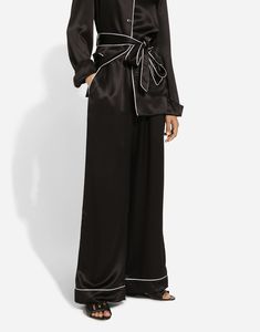 Stretch silk satin pajama pants with contrasting piping: Black Stretch Dolce high waist Front slant pockets Faux fly on the center front Inner leg: 77 cm Hem: 30.4 cm The model is 175 cm tall and wears a size IT 40 Made in Italy Elegant Black Pants Set, Elegant Black Long Pants Set, Black Satin Loungewear Bottoms, Elegant Black Pajama Party Set, Elegant Black Wide Leg Pants For Loungewear, Black Satin Wide-leg Pants, Elegant Wide Leg Bottoms For Pajama Party, Wide Leg Black Pants For Pajama Party, Chic Black Wide Leg Pants For Daywear