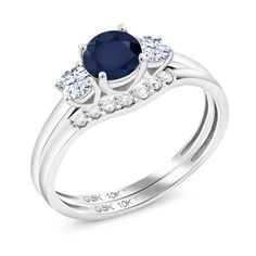 a white gold ring with an oval blue sapphire and round diamonds