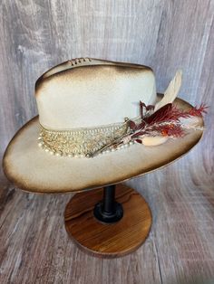 This gorgeous soft brim wool fedora shines with elegance. It's torched to perfection. It has gold accents and a pearl beaded band. It has an adjustable drawstring inner band to fit most size heads. Luxury Brimmed Fedora For Fall, Elegant Flat Brim Fedora For Western-themed Events, Elegant Fedora For Western-themed Events, Elegant Fall Hat Bands For Western-themed Events, Elegant Brown Felt Hat For Western-themed Events, Gold Wide Brim Fedora For Festivals, Elegant Flat Brim Hat For Festivals, Gold Fedora With Short Brim For Festivals, Gold Fedora Hat For Rodeo