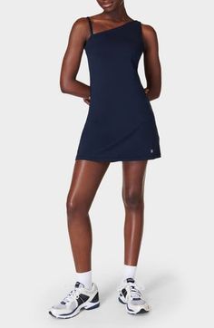 High-stretch fabric offers easy movement in this sporty dress with an asymmetric neckline, a removable strap and built-in shorts with drop-in side pockets. 31" length; 4" inseam; 18" leg opening (size Medium) One-shoulder neck Removable, adjustable strap Shelf bra Built-in shorts underneath with drop-in pockets Moisture-wicking fabric engineered for dryness and comfort 79% polyester, 21% elastane Machine wash, dry flat Imported Stretch Mini Dress With Built-in Shorts, Short Summer Tennis Dress For Workout, Stretch Sleeveless Dress With Built-in Shorts, Blue Sleeveless Workout Dress, Blue Stretch Sports Dress, One Shoulder Athleisure Activewear For Sports, Athleisure Fitted Mini Tennis Dress, Stretch Mini Tennis Dress With Built-in Shorts, Mini Tennis Dress With Built-in Shorts For Workout