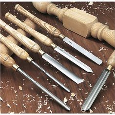 a wooden table topped with different types of knives