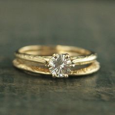 two gold rings with a diamond on top