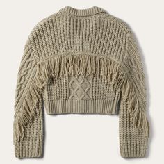 This cozy, wool-blend cable-knit cardigan sweater has a soft tan color, a front-button closure and stylish fringe accents at the back yoke and sleeves. Waist length, with longer, flowing sleeves, it offers easy elegance when worn with jeans, or a dash of bohemian flair when dressed up. Cable-Knit Fringe At Back Yoke And Sleeves Large Fold Down Collar Oversized Buttons 85% Acrylic, 15% Wool Imported Fringed Cardigan, Knit Fringe, Flowing Sleeves, Cable Knit Sweater Cardigan, Fringe Cardigan, Cut Tees, Free Spirit Style, Wide Trousers, Fringe Sweater