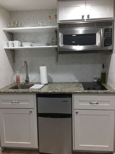 a kitchen with stainless steel appliances and white cabinets