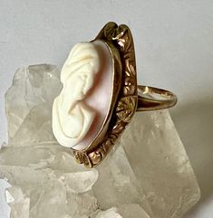 "a gorgeous antique cameo ring in two golds with finely engraved design work. the cameo was cut from shell and is in almost perfect condition. ring is marked 10k and has been sized, has very little wear for an antique. some slight bends in the band. size: measures a 4.25, should fit more like a 4.5 height of face; just under 15/16\" height off finger: 5/16\" width of inner band: 1mm" Cameo 14k Gold Ring, Gold Cameo Ring Jewelry, Vintage Adjustable Cameo Rings, Antique Yellow Gold Cameo Jewelry, Antique Yellow Gold Cameo Ring, Jewelry Charms Pendants, Cameo Ring, Almost Perfect, Initial Ring