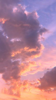 an airplane is flying in the sky at sunset