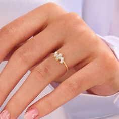 a woman's hand with pink manicures and a ring on her finger