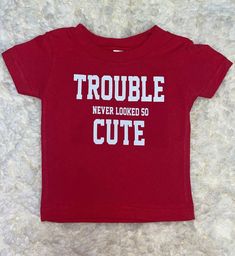 Trouble Never Looked So Cute TShirt Available in red  Sizes 6months, XS, Small, Medium, and XL  *hang to dry and only wash in cold water due to the possibility of vinyl peeling with heat application* Cute Letter Print T-shirt For Playtime, Cute Cotton T-shirt With Name Print, Unisex Red Cotton T-shirt, Fun Red T-shirt With Name Print, Funny Red Crew Neck Top, Red Fun T-shirt With Funny Print, Fun Red T-shirt With Funny Print, Red Letter Print Unisex T-shirt, Red T-shirt With Funny Print