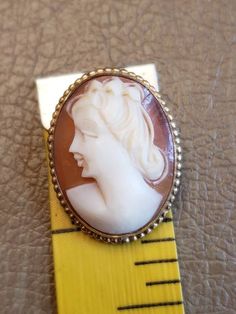 This is a vintage AMCO cameo brooch/pendant. It is oval and is stamped 1/20 14 K GF. The cameo measures just over .75 x a bit over 1 inch. Don't forget to stop in at my other Etsy shop... http://www.etsy.com/shop/xtdesigns. Follow me on Twitter at... MyYiayiaHadThat@MyYiayiaHadThat. If you have a wish list or are looking for something specific, please ask. I may have exactly what you are looking for. As always please convo me with any questions or concerns regarding this item or with any interna Vintage Oval Brooch With Cabochon, Vintage Oval Cabochon Brooch, Gold Oval Cameo Brooch, Collectible Oval Cameo Brooch, Collectible Oval Cameo Brooches, Antique Gold Oval Brooch, Antique Gold Oval Brooches, Antique Oval Cameo Brooch, Antique Gold Brooch With Oval Cabochon