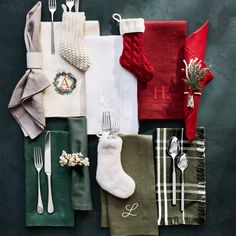 christmas table setting with stocking, napkins, and silverware on black background