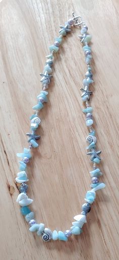 This necklace is made with starfish beads, conch shell beads, fish beads, tan seed beads, and turquoise chip beads. Toggle clasp. Measures 21 inches long end to end. Beaded Long Necklace, Ocean Beaded Necklace, Shell Necklace Diy, Marine Jewelry, Bracelets With Beads, Gemstone Accessories, Beads Projects, Ocean Dress, Beachy Necklace