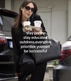 a woman in black carrying a bag and drinking from a cup with the words stay pretty, stay educated, outdress everyone prioritize yourself be successful