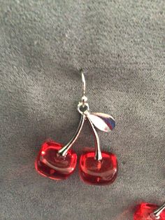 "(7018) Cherries necklace and earrings  Cherries are silver alloy and resin, 1 1/8\" x 1 1/8\". Earrings are on silver plate ear wires. Necklace is on sterling silver chain, 18\"." Glass Dangle Jewelry For Parties, Party Glass Dangle Jewelry, Silver Glass Jewelry For Party, Party Jewelry In Silver With Glass Material, Silver Glass Dangle Earrings, Silver Glass Costume Jewelry, Silver Round Resin Earrings, Silver Resin Pendant Jewelry, Nickel-free Silver Resin Earrings