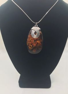 This exquisite necklace, set in sterling silver, is adorned with the finest and most valuable amber in the world - a captivating specimen originating from the Baltic Sea. Its classic Italian chain adds a touch of timeless elegance. For those seeking a jewelry piece of significance, this magnificent pendant is the perfect choice. Since antiquity, Baltic amber has been held in high regard for its unparalleled beauty, warmth, and magical luster. Sterling Silver Chain: 20" (1.25mm) sterling silver I Baltic Amber Gemstone Necklaces, Amber Sterling Silver Necklaces With Cabochon, Amber Cabochon Necklace In Sterling Silver, Amber Sterling Silver Necklace With Cabochon, Amber Cabochon Necklaces In Sterling Silver, Elegant Amber Pendant Necklace, Formal Oval Amber Necklace, Elegant Orange Pendant Necklaces, Formal Orange Cabochon Necklace