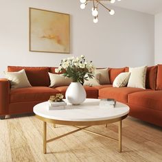 a living room with an orange couch and white coffee table