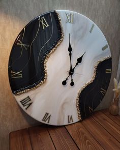 a clock that is on top of a wooden table