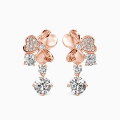 Looking for a nice gift that will bring you good luck? Then these stunning shamrock drop earrings will make for a perfect gift. Each earring features a shamrock pattern while one leaf is embedded with pavéd round-cut stones. Three stones next to the studs add additional sparkle. Treat yourself or bring good luck to your beloved one. Carat Weight: 0.8 ctStone Size: 4.5 mmStone Type: Moissanite/GemstoneNumber of Stones: 2 Stone Shape: RoundStone Color: OptionalCarat Weight: 0.38 ctStone Size: 2.2, Luxury Flower Drop Earrings For Anniversary, Shamrock Pattern, Good Luck To You, Simple Jewelry, Three Stone, Personalized Jewelry, Good Luck, Round Cut, Solid Gold