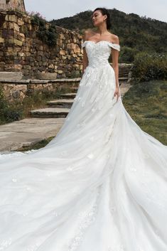 a woman in a wedding dress standing on some steps