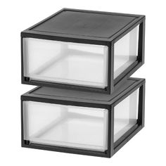 two black boxes are stacked on top of each other, one is empty and the other has clear glass