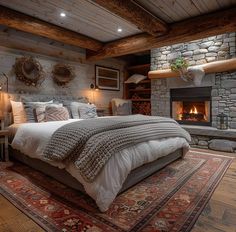 a large bed sitting in a bedroom on top of a rug next to a fire place