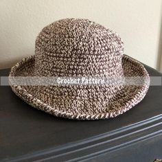 a brown and white hat sitting on top of a dresser