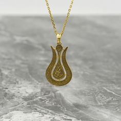 Crafted with intricate detail and spiritual significance, the Ayatul Kursi Tulip Necklace is more than just a piece of jewelry - it's a heartfelt token of faith and love. This exquisite necklace combines the elegance of 925 sterling silver with the luxurious touch of 18K Gold Plating, creating a stunning accessory that symbolizes strength and devotion. Adorned with Islamic calligraphy, including the revered Ayatul Kursi, this necklace is a meaningful gift for Muslim women, moms, or anyone looking to embrace their faith with style. Perfect for birthdays, anniversaries, or any special occasion, this necklace is a beautiful reminder of the power of faith and love. Give the gift of divine elegance with the Ayatul Kursi Tulip Necklace and let its beauty illuminate the heart of the recipient. Si Traditional Teardrop Pendant Jewelry Gift, Spiritual Medallion Necklace With Filigree Details, Spiritual Medallion Necklace With Filigree, Spiritual Filigree Medallion Necklace, Spiritual Medallion Filigree Necklace, Spiritual Filigree Flower Pendant Necklace, Traditional Teardrop Necklace For Gift, Spiritual Necklace With Flower Pendant And Intricate Design, Traditional Flower Pendant Necklace As Gift