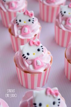 hello kitty cupcakes with pink frosting and bows on them are ready to be eaten