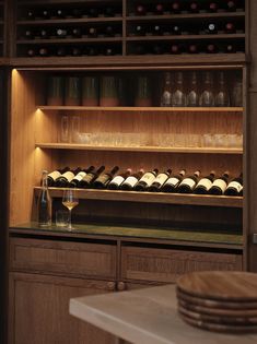 a wine cellar with many bottles and glasses