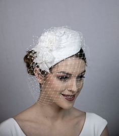 White silk percher hat for the weddings. Stunning classical hat for the bride. This hat is very elegant, classical and stunning  high quality designer hand-made hat. Hat`s bottom layers are hand-blocked from special millinery material named buckram. Base it then covered with soft padding and finally covered with draped mulberry silk fabric. Hat is trimmed with two hand-made silk flowers, leaves and net. Hat is worn on the right hand side of the head and fitted with hat elastic (colour on your choice). Lined inside for cosy and luxory feeling. A lot of attention to the details, quality and technical aspects are paid, when I made this hat. As it is very time consuming hat, then I do not make these more during the high season (from Feb to end June). So at the moment only 1 piece is available Wedding Halo Headpiece, White Pillbox Hat, Elegant Fascinator, White Bridal Flowers, High Tea Wedding, Bridal Birdcage Veils, Face Veil, Bridal Fascinator, Mulberry Silk Fabric