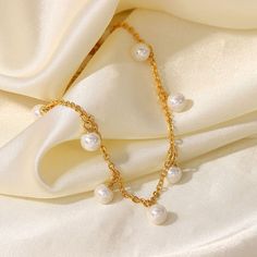 This Pearl Charm Anklet, featuring dainty pearls on an 18k gold-filled chain, embodies delicate elegance. Its graceful design adds a touch of refined beauty to your ankle, making it perfect for both everyday wear and special occasions. Pearl Chain Anklet For Party, Elegant Pearl Chain Anklet For Party, Elegant Pearl Anklets For Party, Dainty Pearl Bracelet With Pearl Charm For Parties, Gold Anklets With Pearl Charm For Gift, Gold Anklets With Pearl Charm As Gift, Delicate Pearl Chain Anklets, Gold Dainty Anklets With Pearl Charm, Dainty Gold Anklets With Pearl Charm