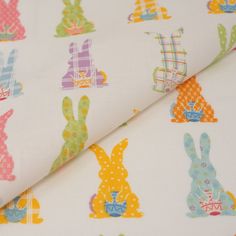 an image of colorful fabric with rabbits on it's back and in the background