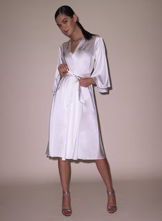 Our best selling Angel Sleeve Robe, now in midi length. Cut from luxe silk charmeuse, with a playful fit and wide sleeves. Wraps across the body and is secured by a sash. Pair with the Frankie Lace Boned Balconette Bra and Thong for an immaculate set.  92% Silk & 8% SpandexDry clean only Model is 5'10 and wearing a size XS/S. Elegant Silk Robe With Tie Waist, Elegant Silk Summer Robe, Elegant Summer Silk Robe, Elegant Daywear Dresses With Kimono Sleeves, Elegant Dresses With Kimono Sleeves For Daywear, Elegant Wrap Robe With Tie Waist, Formal Satin Robe For Spring, Elegant Robe With Tie Waist And Kimono Sleeves, Elegant Satin Robe With Kimono Sleeves