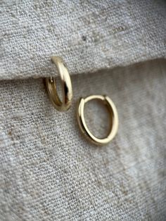 These are great classic little huggie hoops made in solid 9ct yellow gold.  They are oval in shape which keeps them hugging closer to the ear.  The perfect way to bring a bit of warm gold into a cureated ear look although they also make enough impact to be worn alone.   They are 6mm by 10mm across internally and 2mm wide.  I have a variety of huggies and hoops available on my page please check out my other listings.  If you require more of this item than is showing as available to purchase pleas Minimalist 14k Gold Filled Huggie Earrings, Classic Huggie 14k Gold Rings, Classic 14k Gold Huggie Rings, 14k Gold Huggie Rings For Everyday, Everyday 14k Gold Huggie Rings, Classic Hypoallergenic Huggie Hoop Earrings, Classic 14k Gold Filled Huggie Earrings, Classic Gold Small Hoop Huggie Earrings, Classic Oval Huggie Earrings With Polished Finish