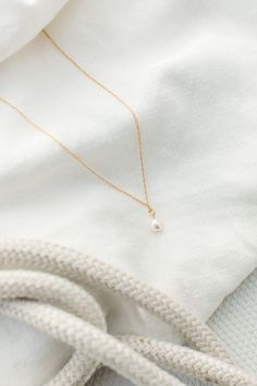 Meet our newest pearl necklace, exquisitely crafted to add an opulent touch to any look. The luxurious design features a single, delectable pearl suspended from a delicate chain, perfectly combining elegance and sophistication into a single refined piece. Enjoy the beauty and grace of this pearl drop necklace, a timeless treasure sure to stand the test of time. Hypoallergenic, Non-Tarnish Freshwater Pearls suspended on a 18”-20” chain Handcrafted with love from San Clemente, California Delicate Pearl Necklace With Pearl Pendant, Delicate Pearl Necklace With Pendant, Timeless Pearl Charm Drop Jewelry, Elegant Teardrop Drop Necklace With Adjustable Chain, Classic Gold Charm Necklace With Pearl Drop, Elegant Teardrop Pendant Pearl Necklace, Graceful Pearl Chain Necklace For Gift, Teardrop Akoya Pearl Necklaces With Pearl Chain, Akoya Pearl Teardrop Necklaces With Pearl Chain