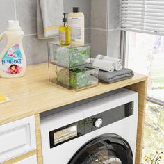 a washer sitting next to a window in a room with lots of clutter on the counter