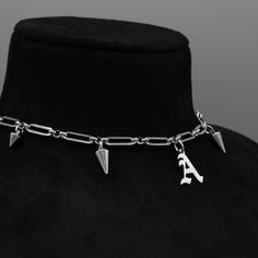 Gothic Style Font Initial Pendant Choker/Necklace, part of our Goth Jewellery Range 15mm x 6mm Solid Stainless Steel Paperclip Chain Gothic Style Stainless Steel Letter Pendant 4 Inch Premium Stainless Steel Adjuster Chain Spiky Gothic Style Choker Necklace Non Tarnish & Waterproof Jewellery Handcrafted in the UK Sizing: Small 11 - 15 Inches (28 - 38cm) Medium 13 - 17 Inches (33 - 43cm) Large 15 - 19 Inches (38 - 48.5cm) Layering Earrings, Goth Jewellery, English Gothic, Choker Necklace Silver, O Ring Choker, Gothic Bracelet, Word Necklace, Gothic Pendant, Pendant Choker Necklace