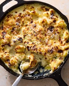 a casserole dish with broccoli and cheese in it on a table