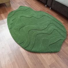 a green rug on the floor in a living room