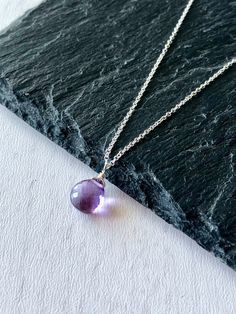 Amethyst Necklace, February Birthstone, Purple Amethyst Teardrop Pendant, Minimalist Jewelry in Gold or Silver, Delicate Gift for February This simple and classy necklace features a micro faceted purple Amethyst teardrop wire wrapped to a dainty chain in your choice of gold filled or sterling silver. This minimalist necklace is ideal for every day wear, and it makes a wonderful gift for a girl born in February, as this is their birthstone. Popular choice for bridesmaids necklaces, this necklace Purple Teardrop Drop Necklace As Gift, Drop Gemstone Crystal Necklace, Purple Briolette Crystal Necklace, Purple Teardrop Gemstone Necklace, Lavender Amethyst Drop Necklace, Purple Amethyst Briolette Necklace, Lavender Amethyst Teardrop Necklace, Purple Teardrop Necklaces For Jewelry Making, Purple Teardrop Necklace For Jewelry Making